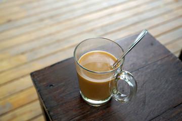 Hot coffee on timber table
