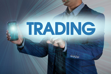 Businessman presses button trading on virtual screens. Business,