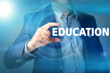 Businessman presses button education on virtual screens. Busines