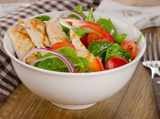 Salad with grilled chicken in  a bowl.