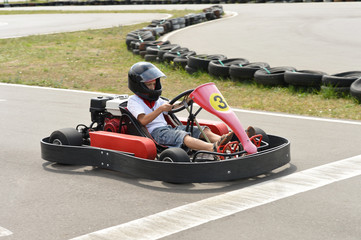 Fototapeta premium Teenage boy sitting in go-kart