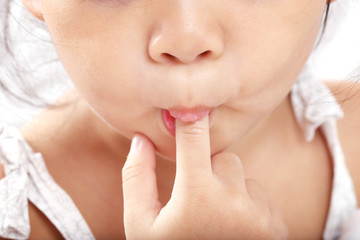 Asian Baby Girl, Toddler, Sucking her Finger Isolated on White Background.