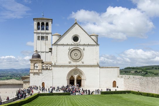 Tourists visit the basilica of St. Francis of Assisi, Umbria, Italy