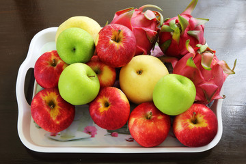 fruit in a plastic tray on wood table