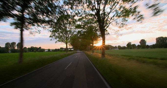 Driving a car  - POV - Road into the Sunset