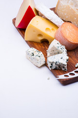 Cheeses on chopping board