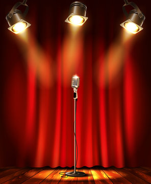 Stage with red curtians, microphone and spotlight.