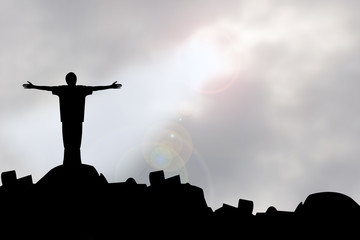 sillouette man with faith praying under god light