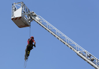 firefighter with the rope climbing in firehouse