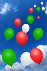 Red, green, white balloons on blue sky