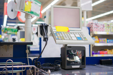Empty cash desk with computer terminal in supermarket