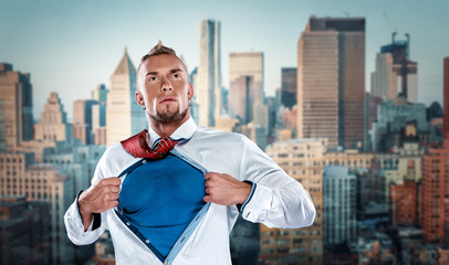 businessman acting like  super hero and tearing his shirt off