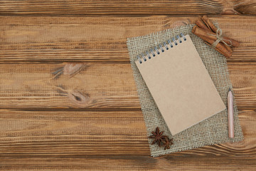 Blank notepad for copy space and herbs on wooden table