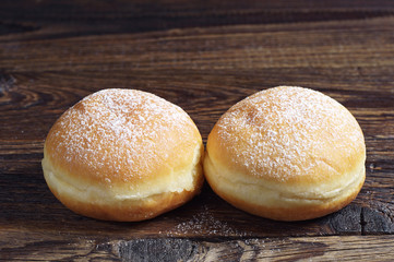 Two doughnuts with powdered sugar