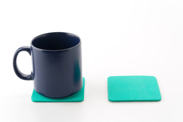 cup and coaster on white background