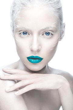 Beautiful girl in the image of albino with blue lips and white eyes. Art beauty face. Picture taken in the studio on a white background.