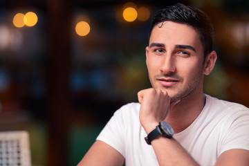 Young Man Sitting in a Restaurant