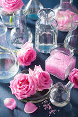 alchemy and aromatherapy with rose flowers and chemical flasks