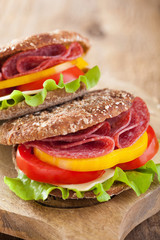 healthy sandwich with salami tomato pepper and lettuce