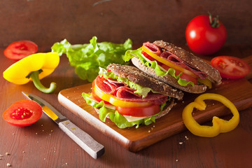 healthy sandwich with salami tomato pepper and lettuce