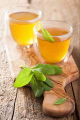 herbal sage tea with green leaf in glass cup