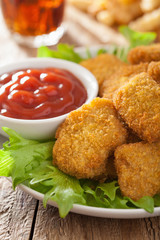 fast food chicken nuggets with ketchup, french fries, cola