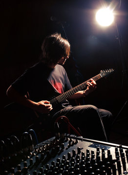 guitarist recording and playing guitar