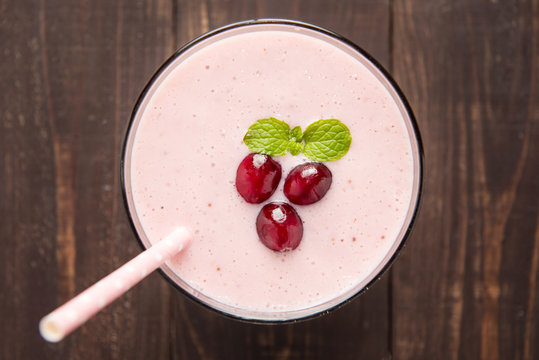 Cranberry fruit smoothie on wooden background, healthy eating.