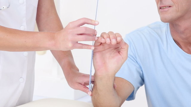 Doctor measuring arm with goniometer