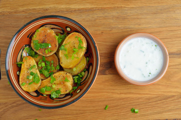 Oven-baked potatoes with herbs. Top view.