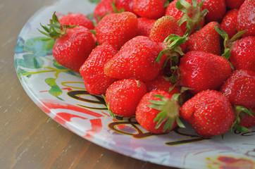 Ripe red strawberries on wooden table