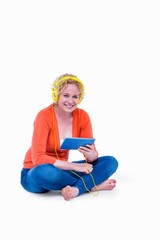 Pretty blonde listening music with her tablet computer