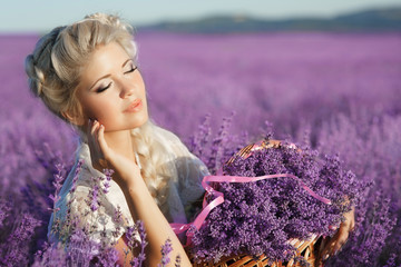 Beautiful young woman lavender flowers girl in lavender
