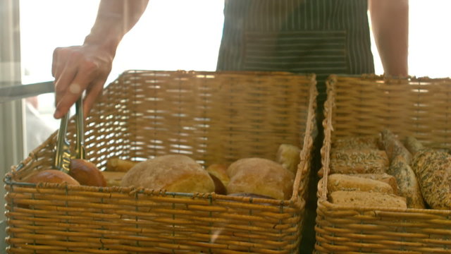 Baker arranging bread in baskets