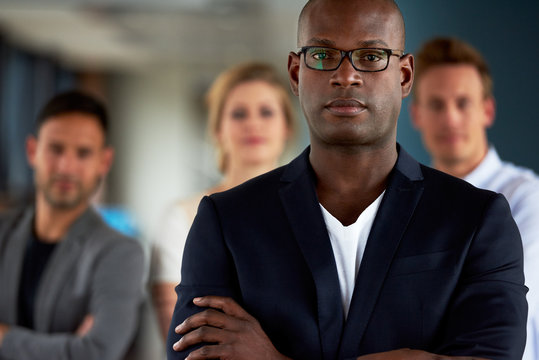 Black Male Executive With Arms Crossed Facing Camera