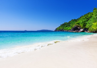 Fototapeta na wymiar Tropical white sand beach arainst blue sky. Similan islands, Tha