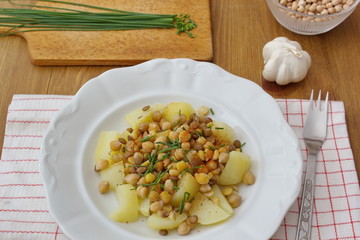 healthy vegan food - chickpeas, peas and lentils served with potatoes and chive