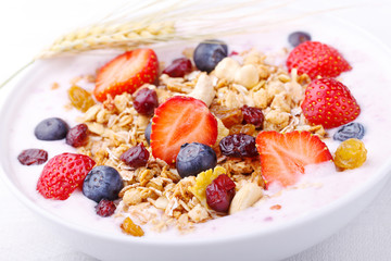 Healthy breakfast - Fresh fruits, yogurt and granola in a white bowl - Close-up 