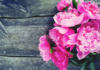 beautiful fresh peonies on wooden surface