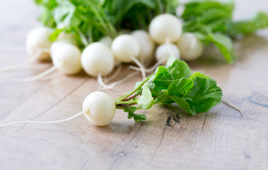 white radishes on wooden surface
