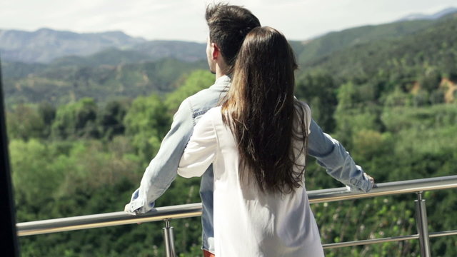 Couple in love hugging on terrace, slow motion shot at 240fps
