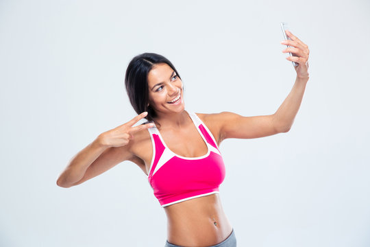 Happy fitness woman making selfie photo