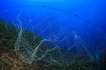 Abandoned fishing net underwater causes environmental damage