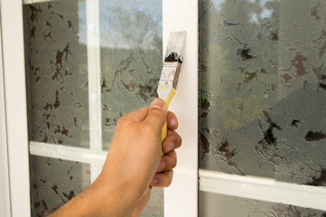 painting the window with brush