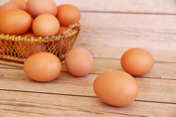 Eggs in the basket on wooden background