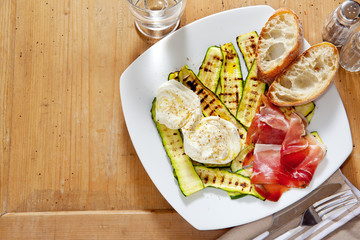 healthy summer salad with grilled zucchini, mozzarella and prosc