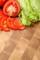 tomato and salad on a chopping board