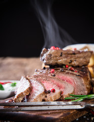 Beef steak on wooden table