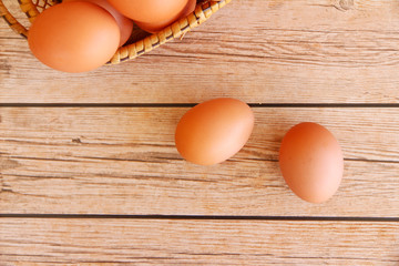 Eggs in the basket on wooden background