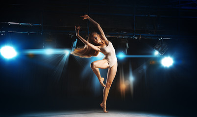 Charming young blonde ballet dancer posing on stage - obrazy, fototapety, plakaty